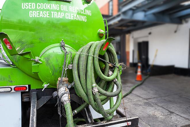 a grease trap being pumped by a sanitation technician in Chester